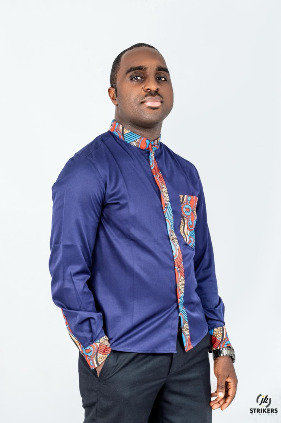 François-Xavier Djimgou Ngameni, de trois quarts, chemise bleu nuit à motifs.